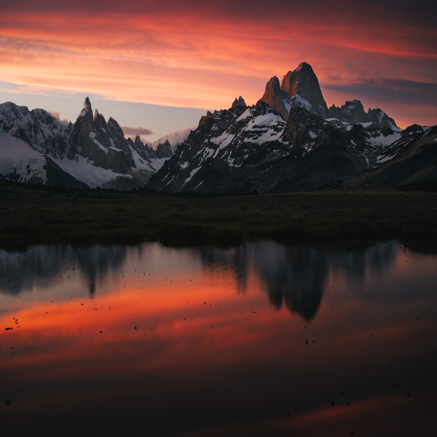 Cerro Torre and Fitz Roy reflected in a pond.