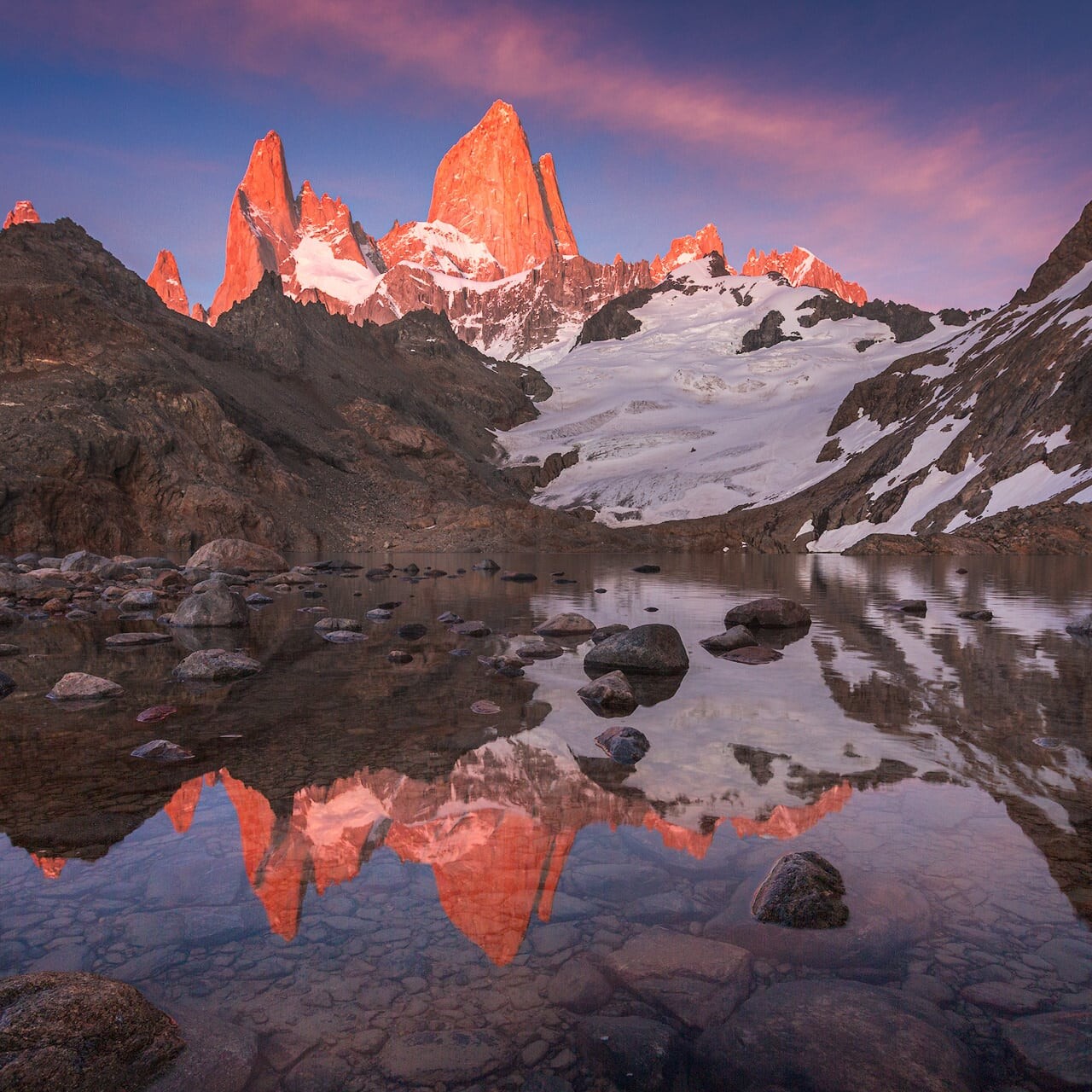Laguna de los Tres — Alpenglow on Fitz Roy east face at sunrise Alpenglow on Fitz Roy and Cerro Poincenot reflected in Laguna de los Tres at sunrise, El Chaltén, Patagonia