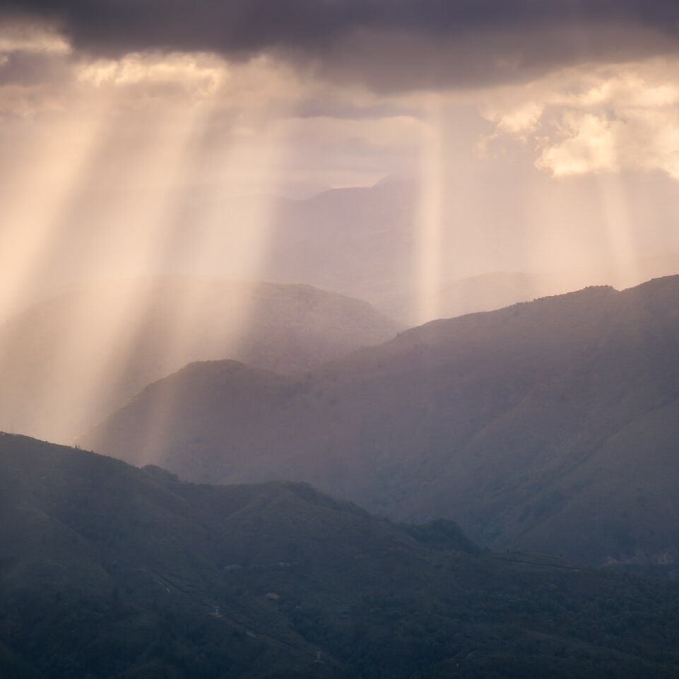 Shafts of light over distant hills in New Zealand