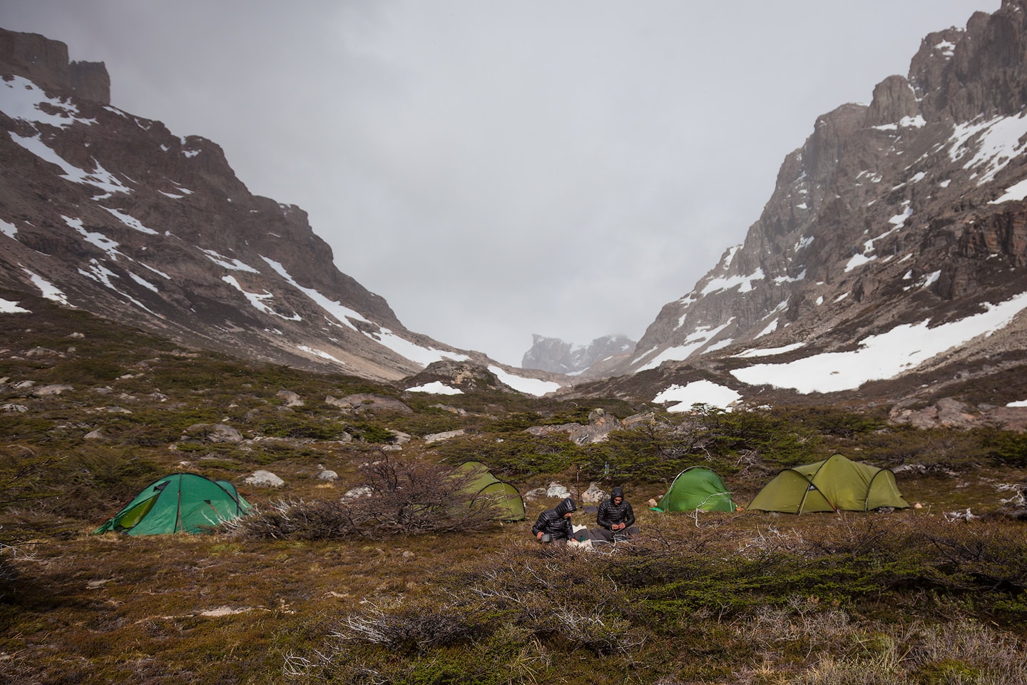 Hikers having breakfast in front of their tents.